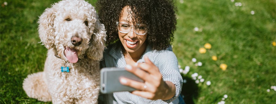 Woman taking a selfie with a dog